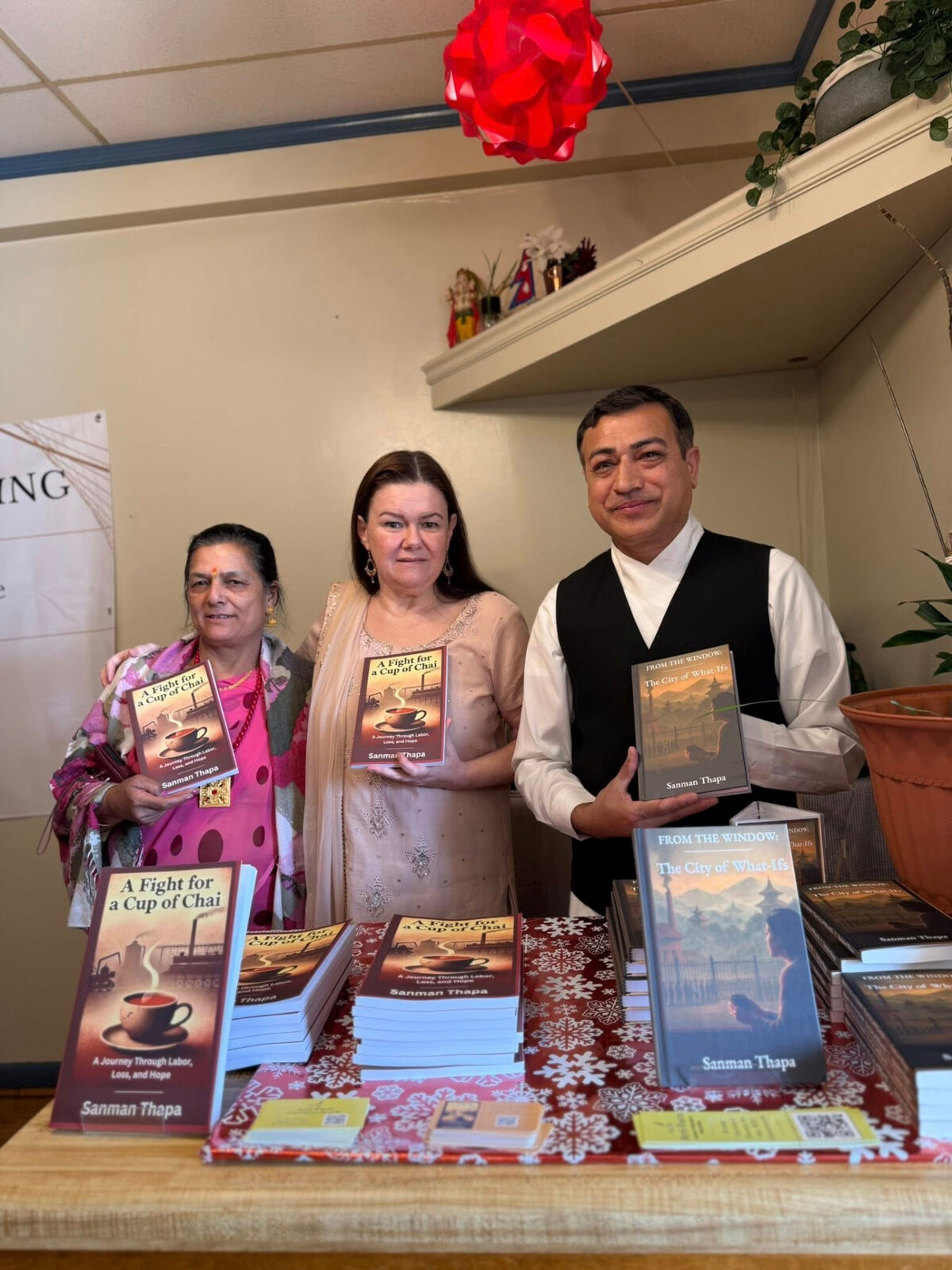 Three readers holding A Fight for a Cup of Chai and From the Window