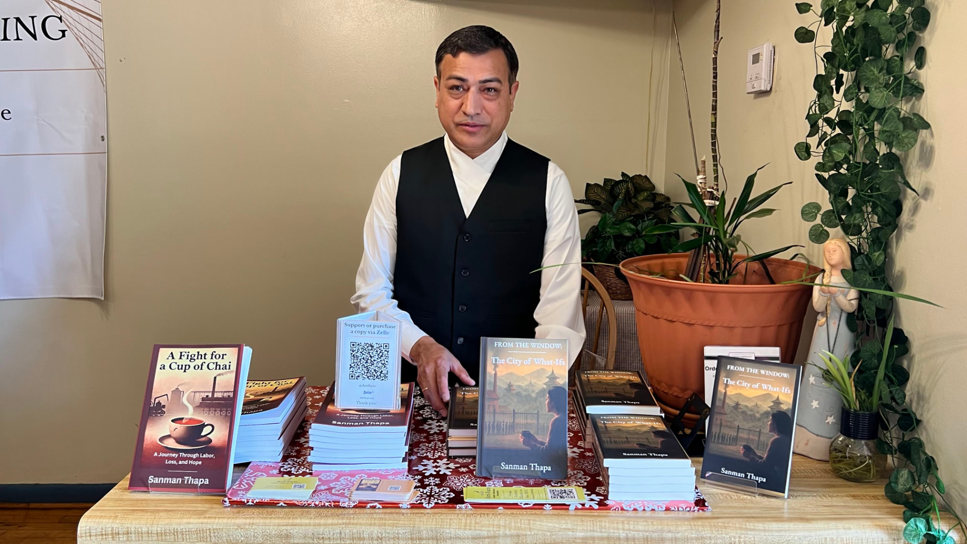 Sanman Thapa at the signing table with stacked copies of both titles