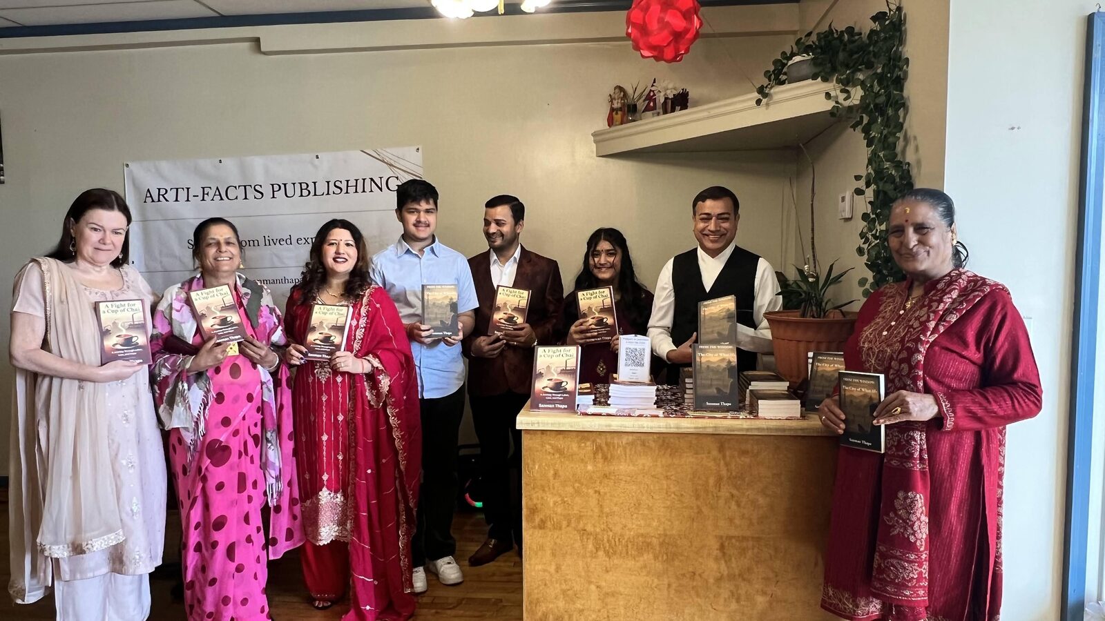 Guests smiling with copies of the books at the launch venue
