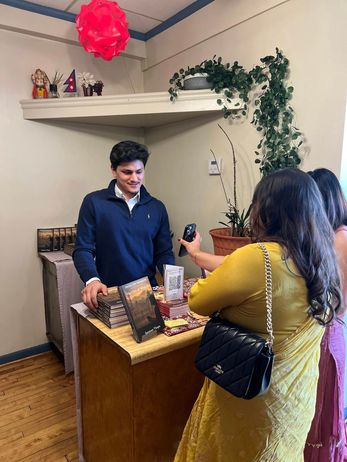 A reader photographing the display of copies at the signing desk