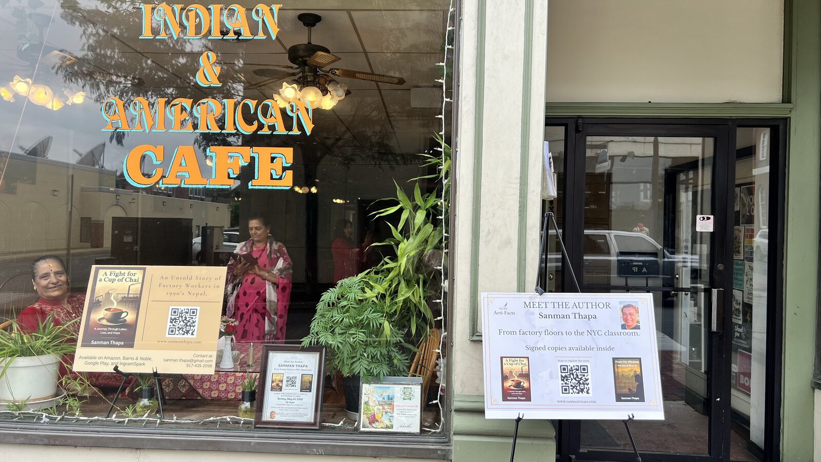 Close view of the cafe window with signed copy signage